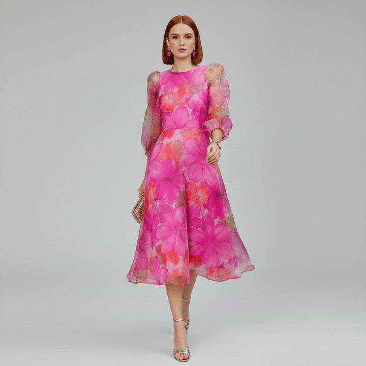 Close-up of vibrant blue & pink floral print on a women's A-line midi dress. Features delicate puff sleeves, ideal for spring.