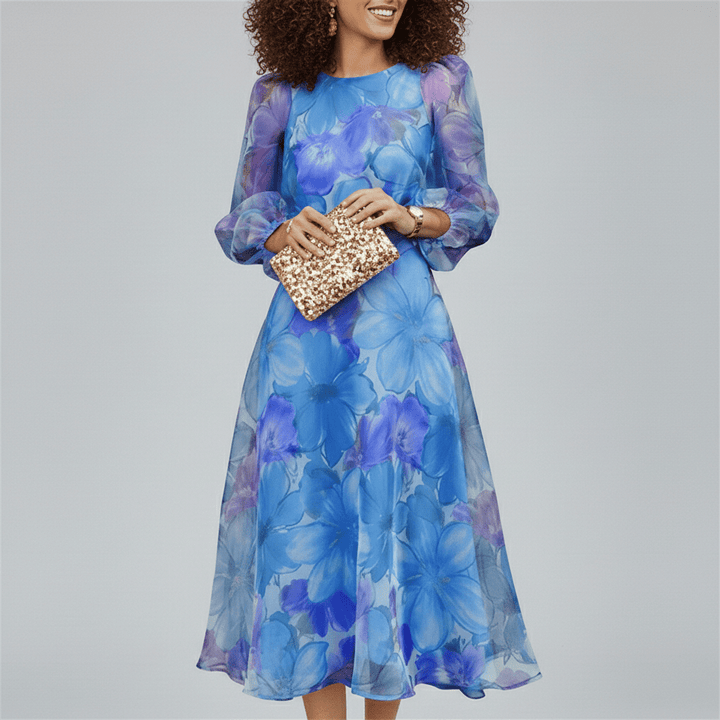 Side view of an elegant A-line midi dress. Women's vibrant blue & pink floral print, puff sleeves, perfect for formal events.