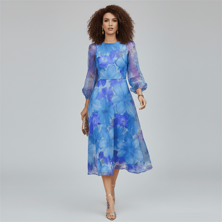 Stylish women's midi dress for wedding guests. Features vibrant floral print, puff sleeves & A-line silhouette in blue & pink.