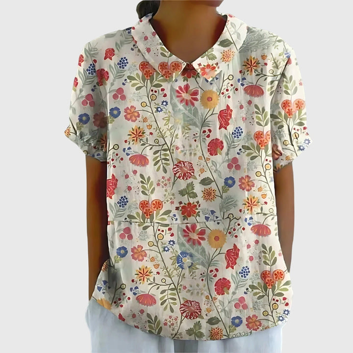 Flat lay: Front view of an elegant floral women's blouse, highlighting comfortable fit & stylish print.