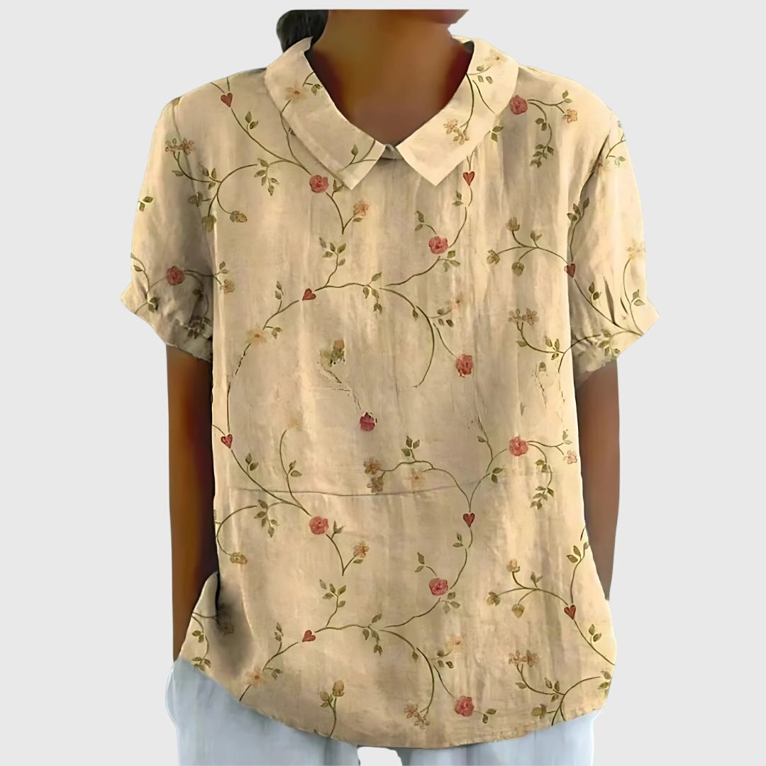 Close-up of vibrant floral print on a women's elegant blouse, showcasing intricate details & quality.