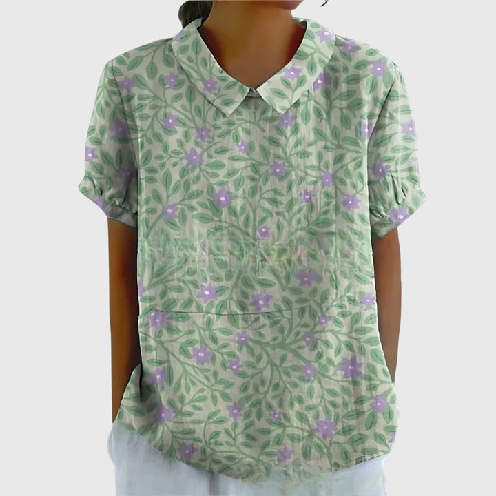 Casual women's floral top, perfect for relaxed spring days, styled with simple, elegant accessories.