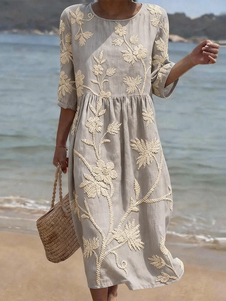 Chic women's summer midi dress featuring beautiful floral embroidery, three-quarter sleeves, and flattering midi length.