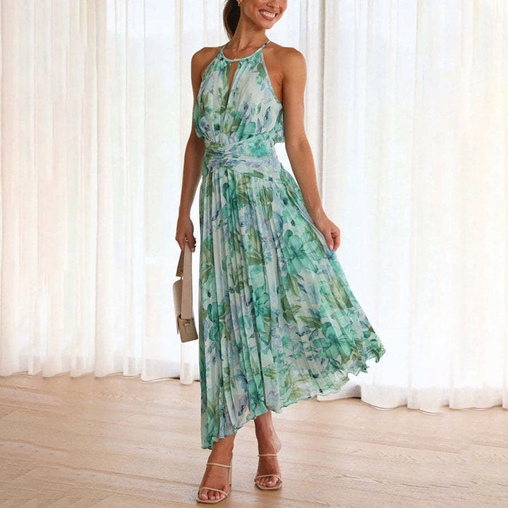 Elegant women's floral halter neck maxi dress with a flattering twist waist and flowing pleated skirt, perfect for summer events.