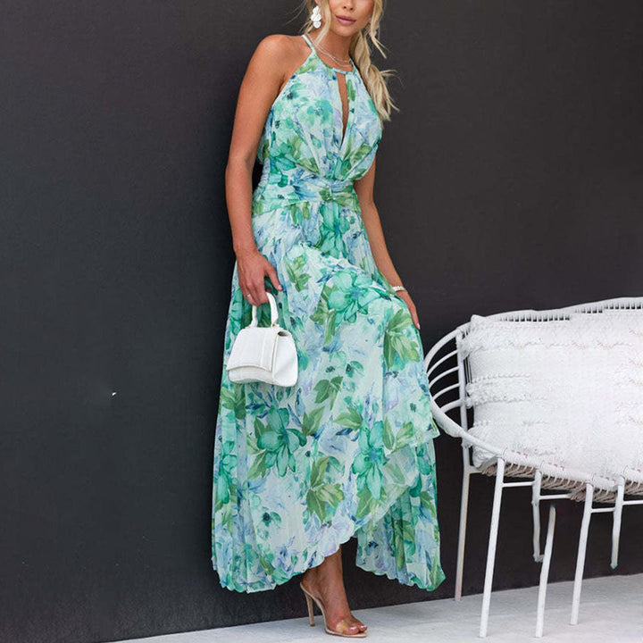 Feminine floral halter maxi dress, ideal for wedding guests & garden parties. Features a chic twist waist & pleats.