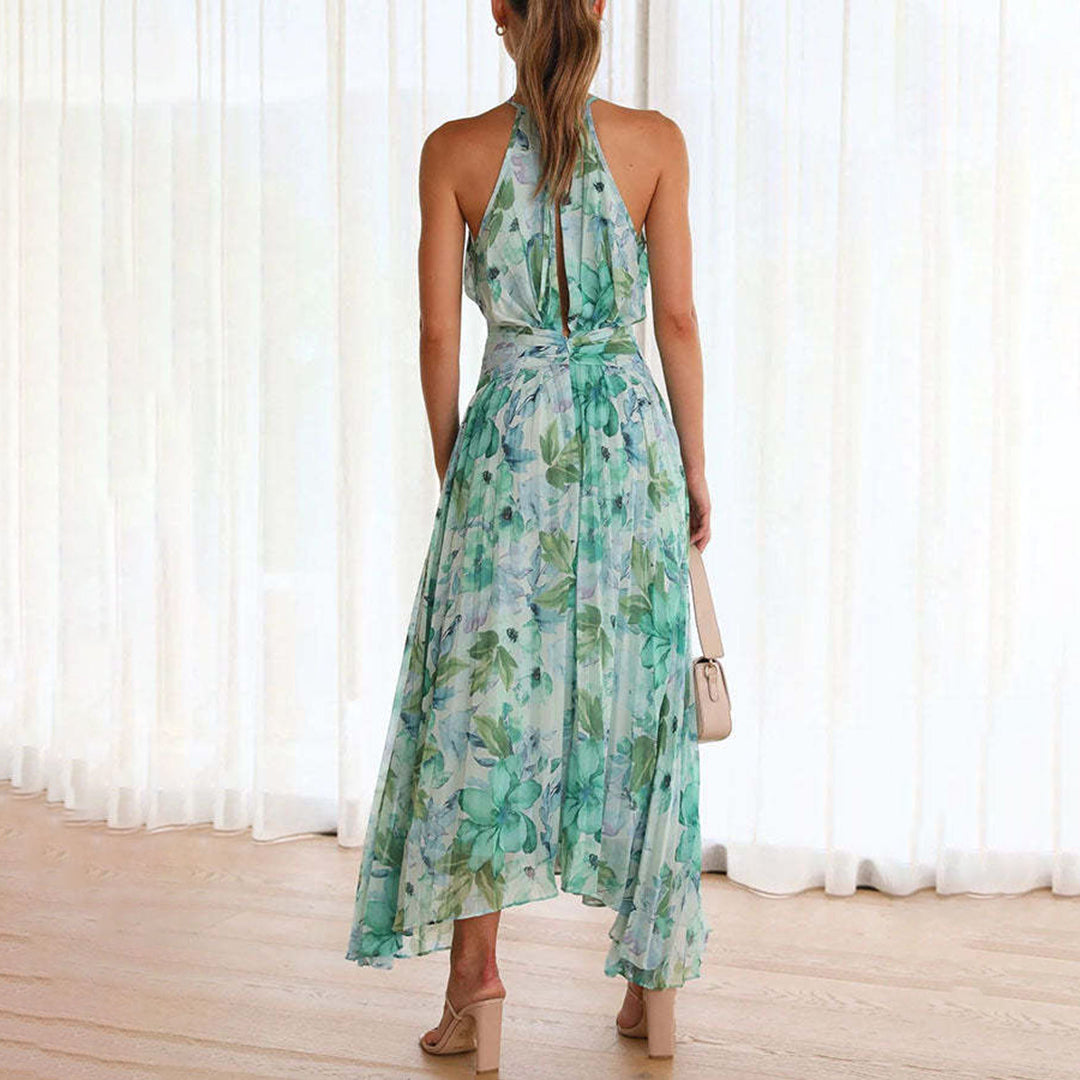 Stunning women's pleated maxi dress with a vibrant floral print, elegant halter neck, and stylish twist waist detail.