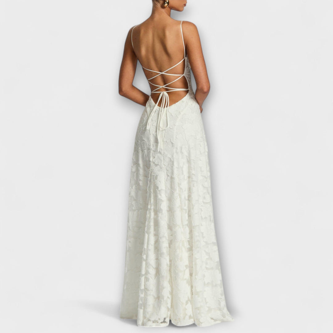 Close-up of elegant women's maxi dress with intricate floral lace detail, ideal for a special event.