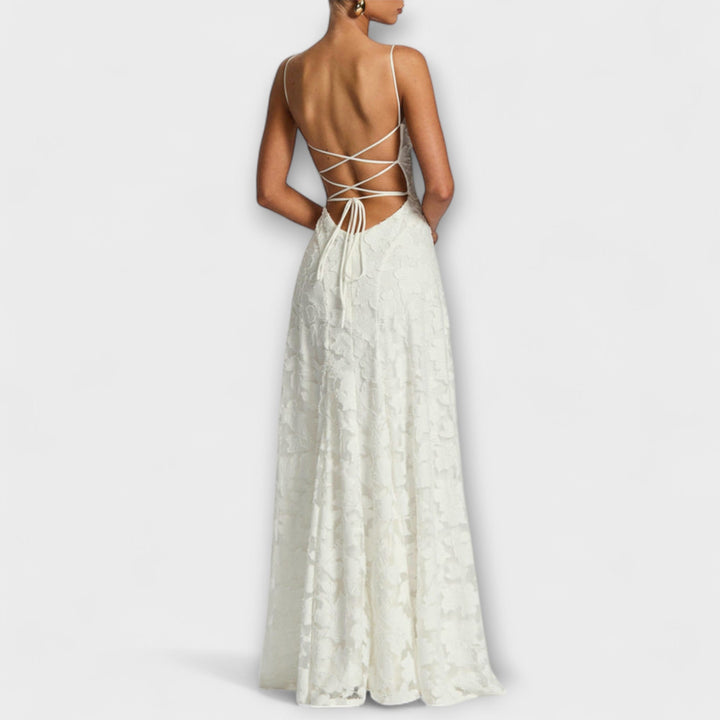 Close-up of elegant women's maxi dress with intricate floral lace detail, ideal for a special event.