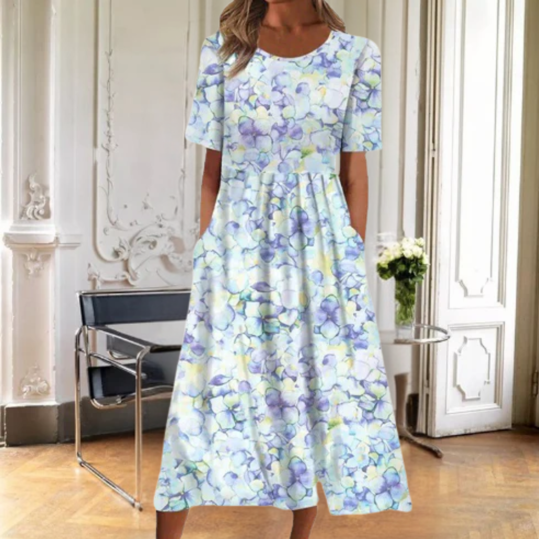 Chic women's floral midi dress. Features short sleeves, round neck & flared skirt for an elegant, casual look.