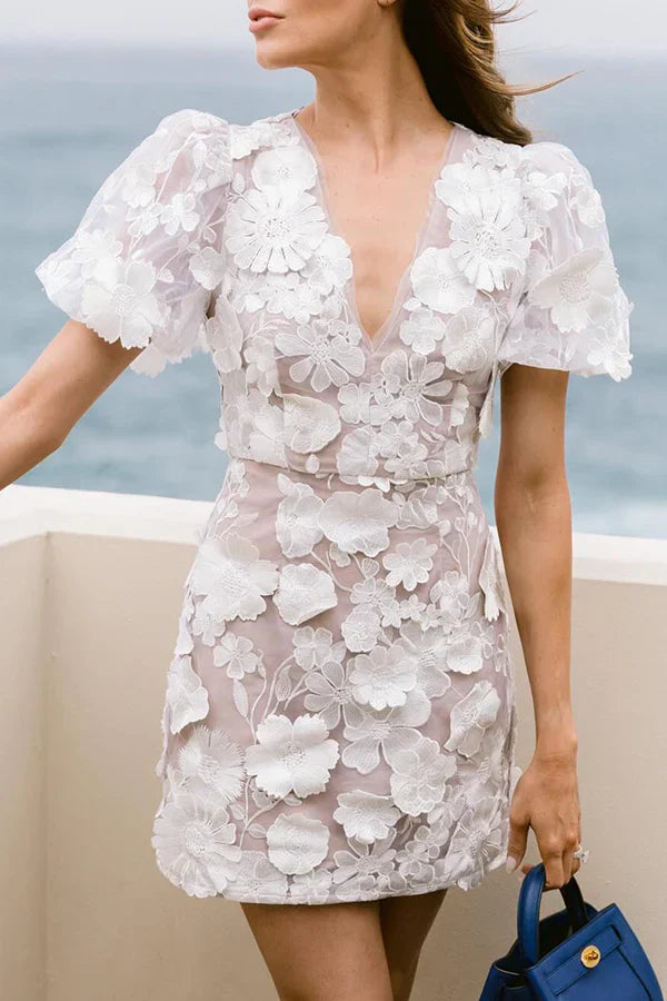 Vibrant floral print mini dress for women, featuring elegant short puff sleeves, ideal for summer celebrations.