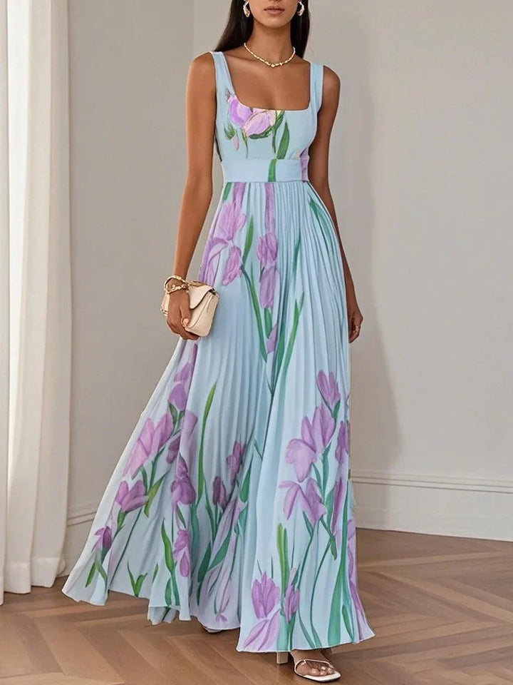 Stylish sleeveless pleated maxi dress with floral print, perfect elegant wedding guest outfit.