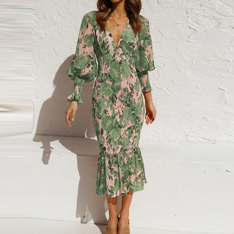 Chic women's midi dress with vibrant floral print, long sleeves, and playful ruffle hem for an elegant look.