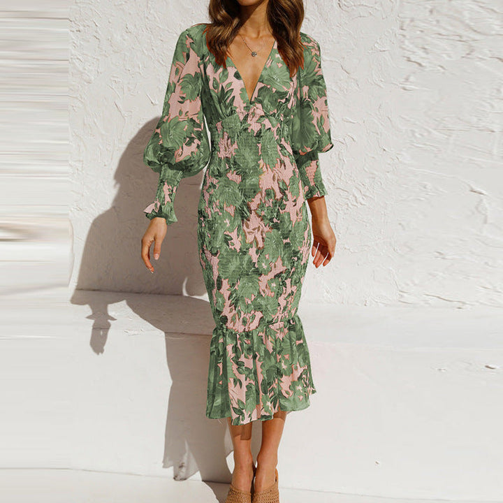 Chic women's midi dress with vibrant floral print, long sleeves, and playful ruffle hem for an elegant look.