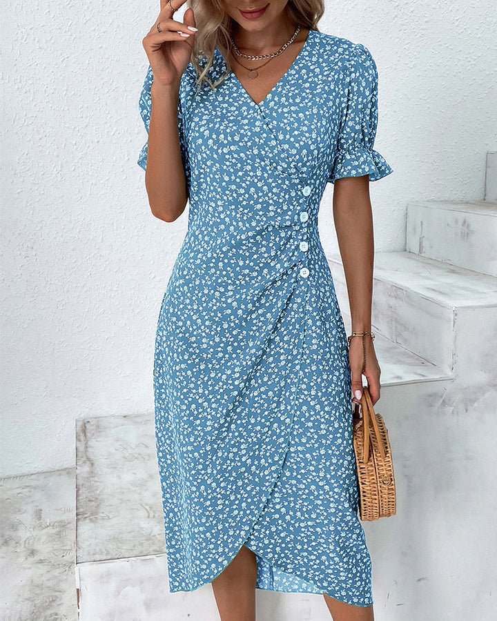 Close-up of vibrant floral print on women's V-neck flowy summer midi dress fabric. Elegant and soft.