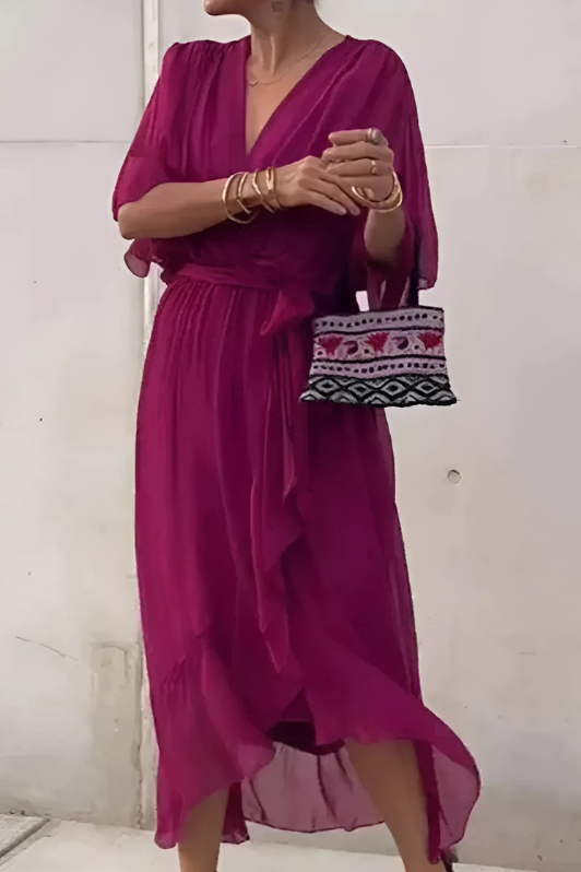 Model wearing a chic women's elegant flowing maxi dress, perfect for a summer evening party or formal occasion.