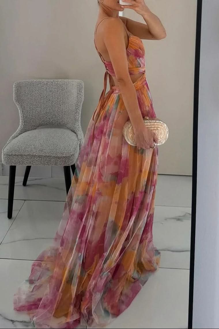 Woman twirling in a colorful flowing sleeveless maxi dress, showcasing its elegant movement & summer style.