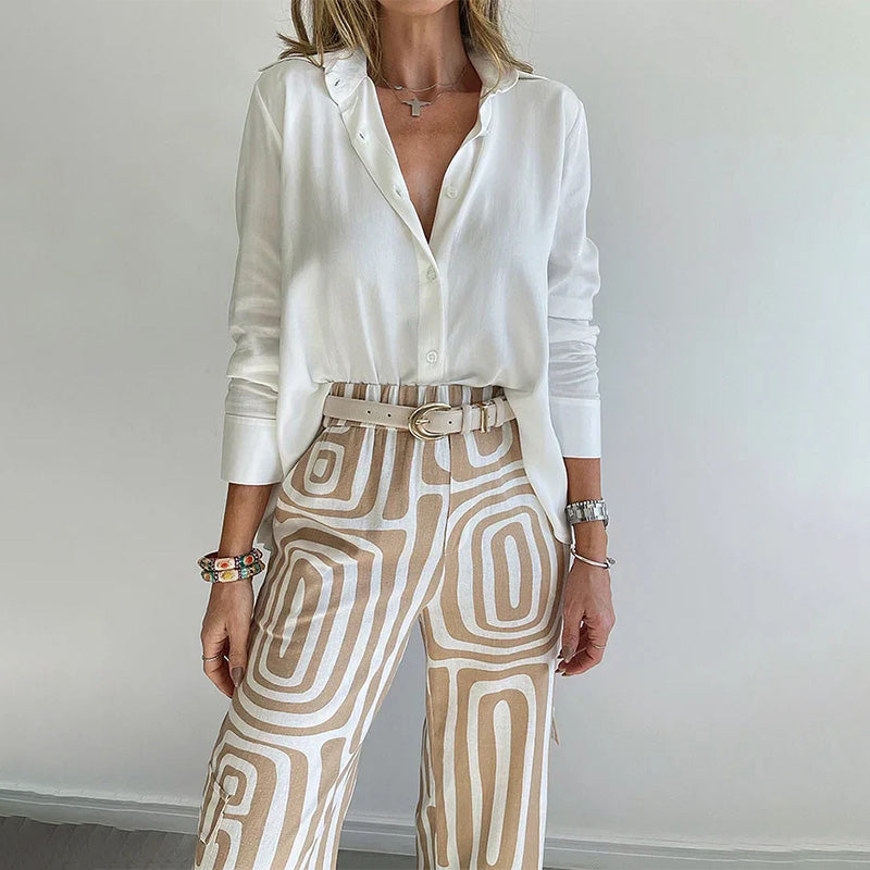 Coordinated women's two-piece set: soft flowing top with stylish patterned trousers.