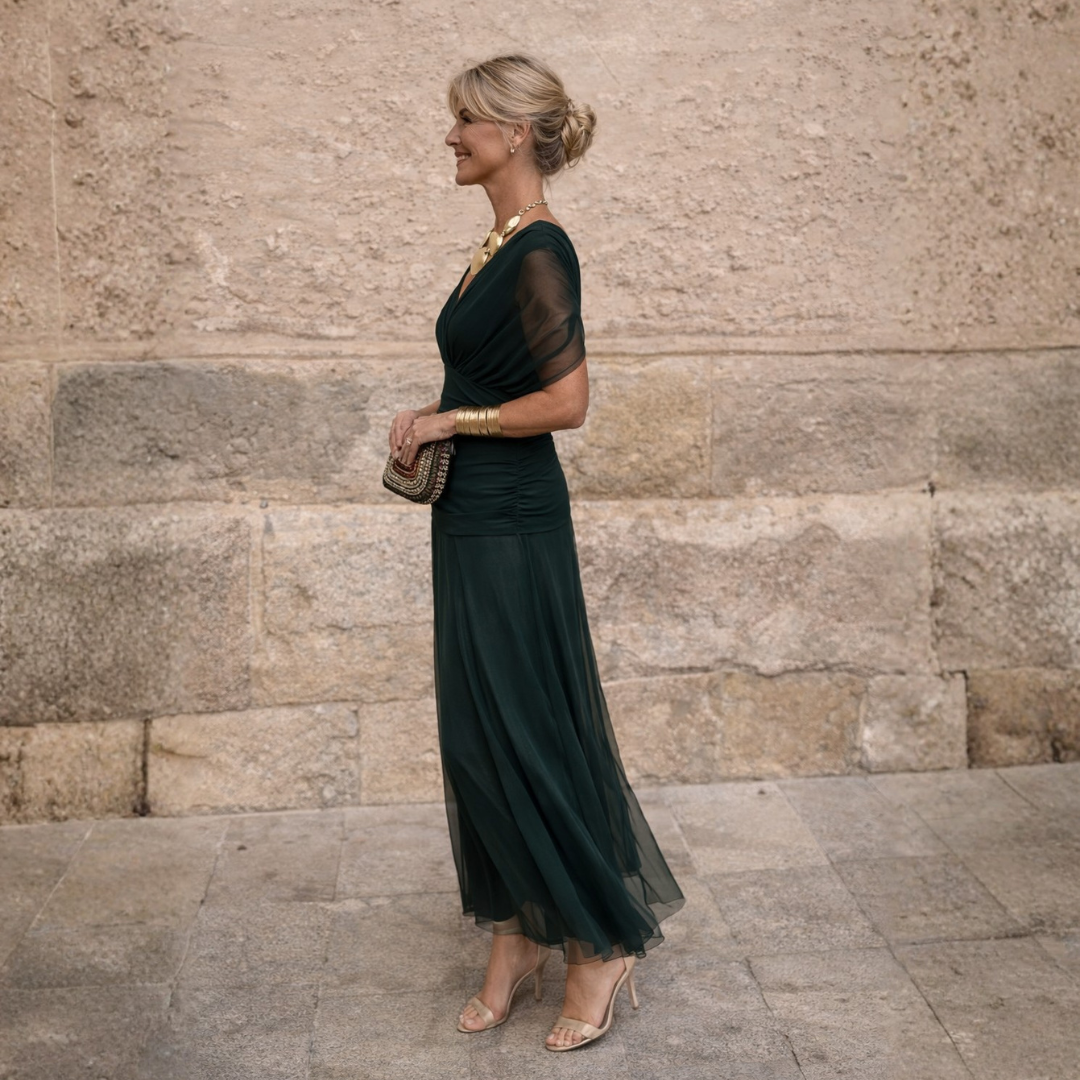 Close-up of the gathered V-neck and delicate flutter sleeves on this elegant women's formal midi dress.