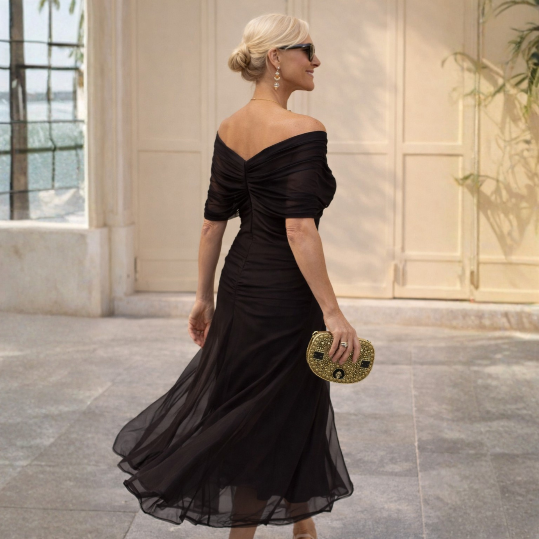 Flattering women's occasion midi dress featuring a V-neck, airy flutter sleeves, and modern gathered detail.