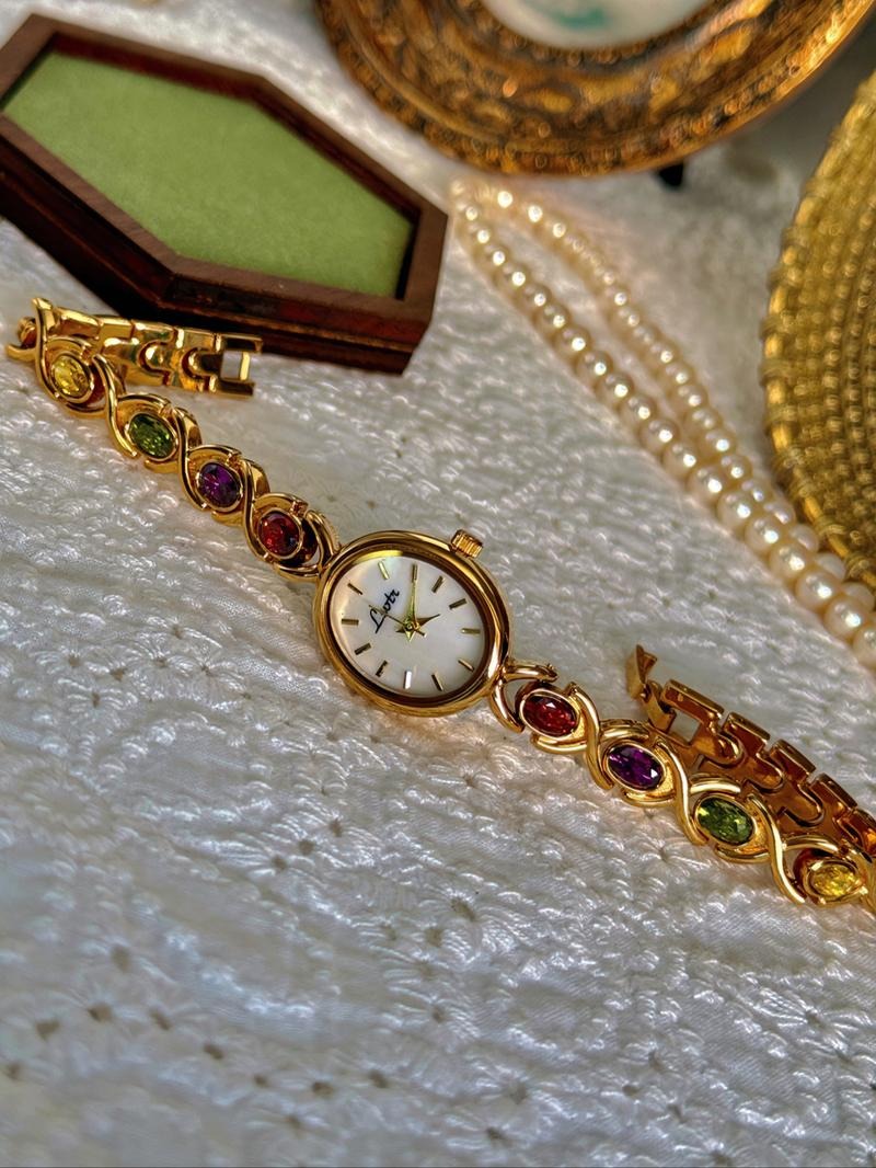 Close-up of women's multicolor gemstone bracelet watch, showcasing intricate jewelry design and elegant style