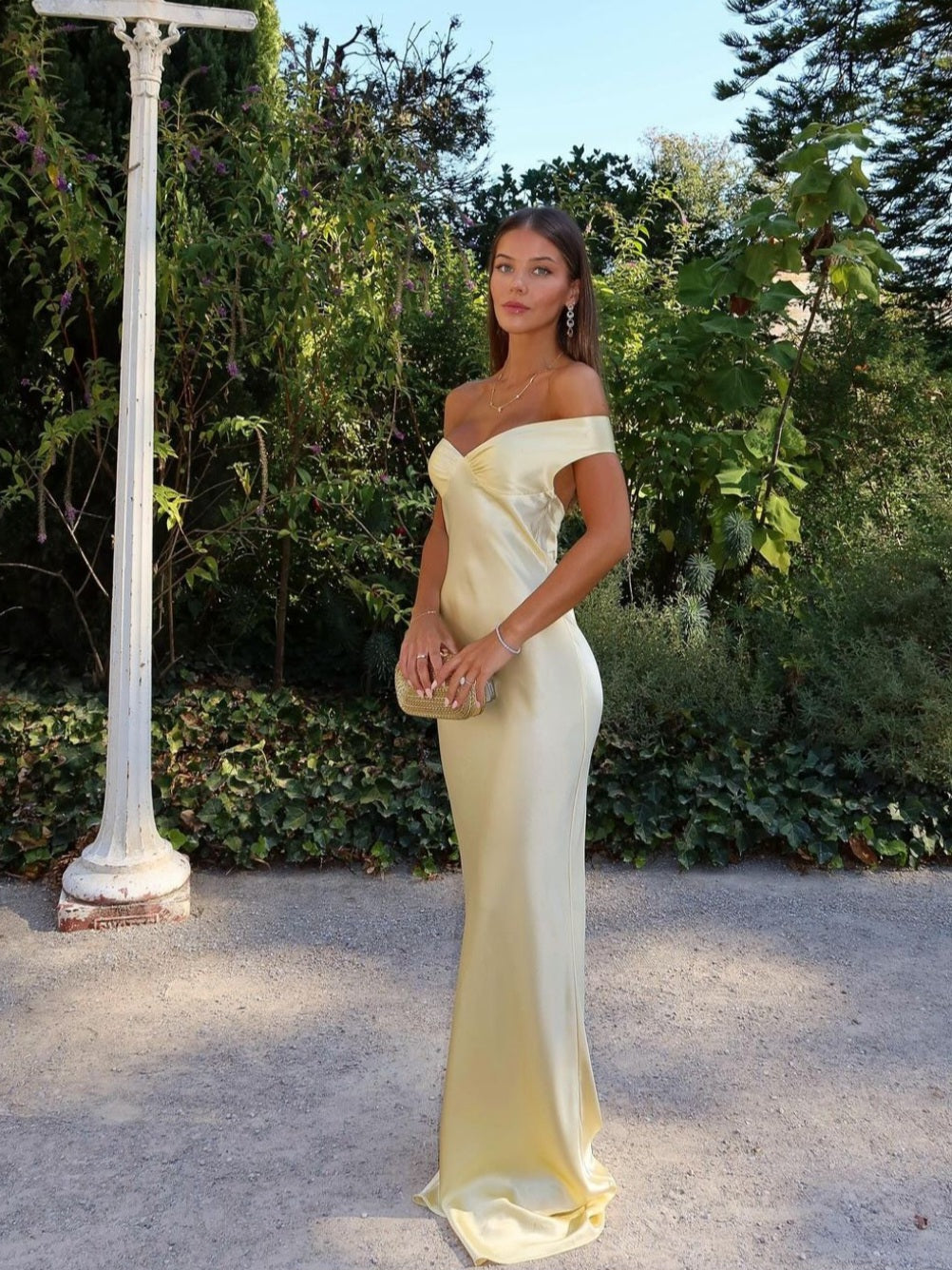 Elegant women's gold off-shoulder maxi wedding guest dress with sweetheart neckline, perfect for formal occasions.