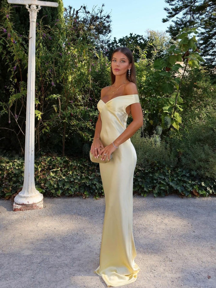 Elegant women's gold off-shoulder maxi wedding guest dress with sweetheart neckline, perfect for formal occasions.