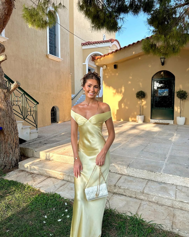 Stunning off-shoulder gold maxi dress for women, an elegant long gown with sweetheart neckline for special occasions.