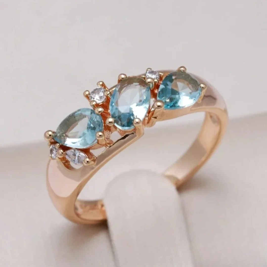 Elegant women's gold ring with a radiant blue zirconia gemstone, perfect as a cocktail or statement ring for special occasions.