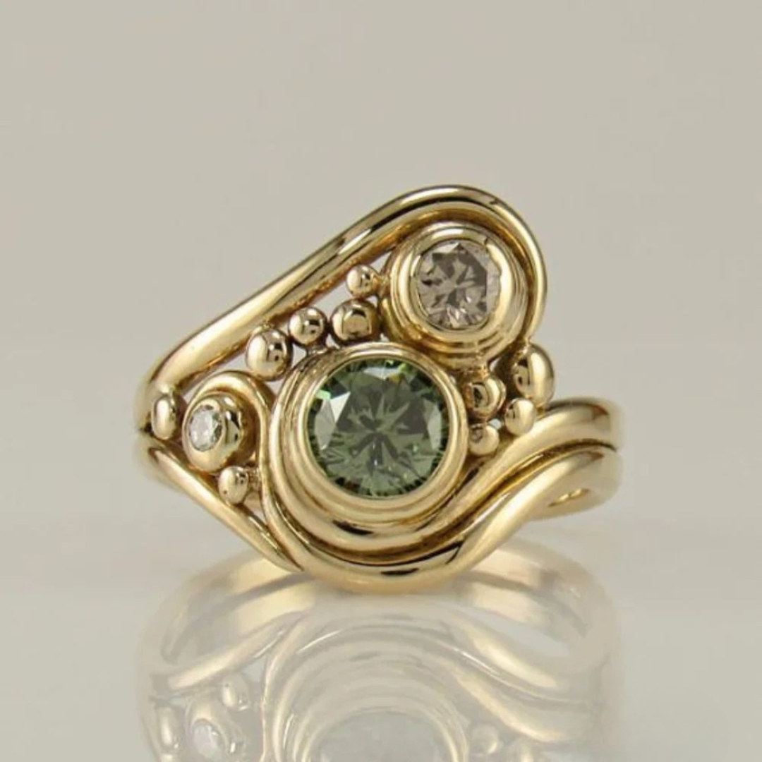 Elegant Women's Gold Ring with Vibrant Green Zirconia. Perfect statement jewellery for special occasions & timeless style.