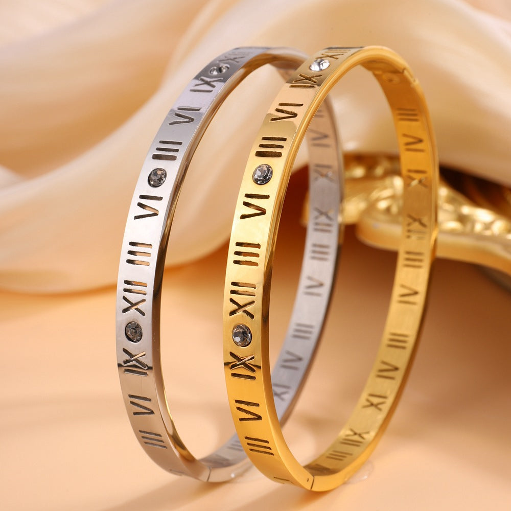 Elegant women's gold-toned titanium Roman numeral bracelet. A stylish and versatile timeless accessory.