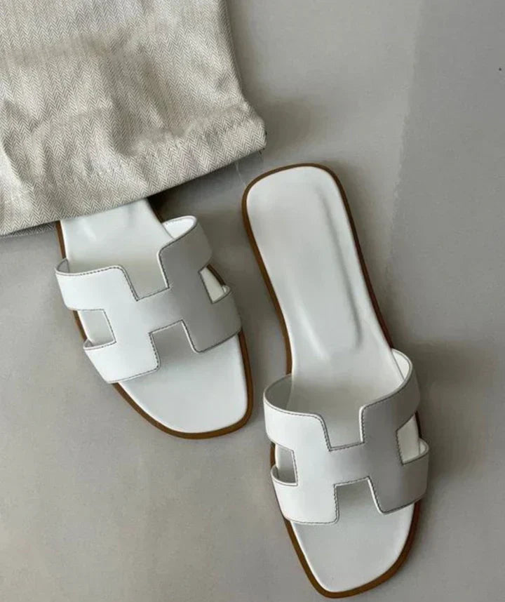 Elegant women's H-strap slip-on sandals with a low heel. Perfect for comfortable summer wear.