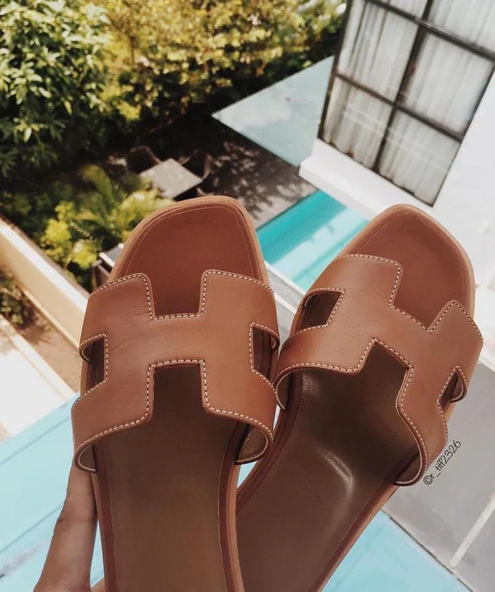 Chic women's H-strap summer sandals. Slip-on design and low heel offer elegance & comfort.