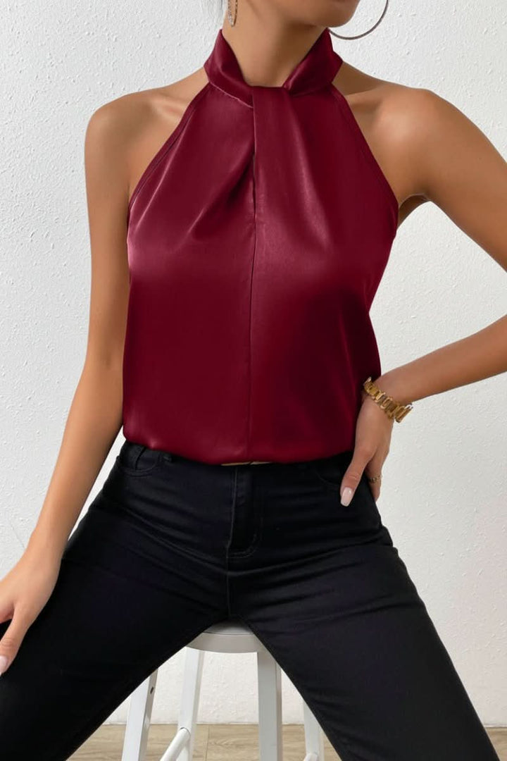 Sophisticated women's sleeveless blouse featuring a trendy halter neck and elegant knot detail.