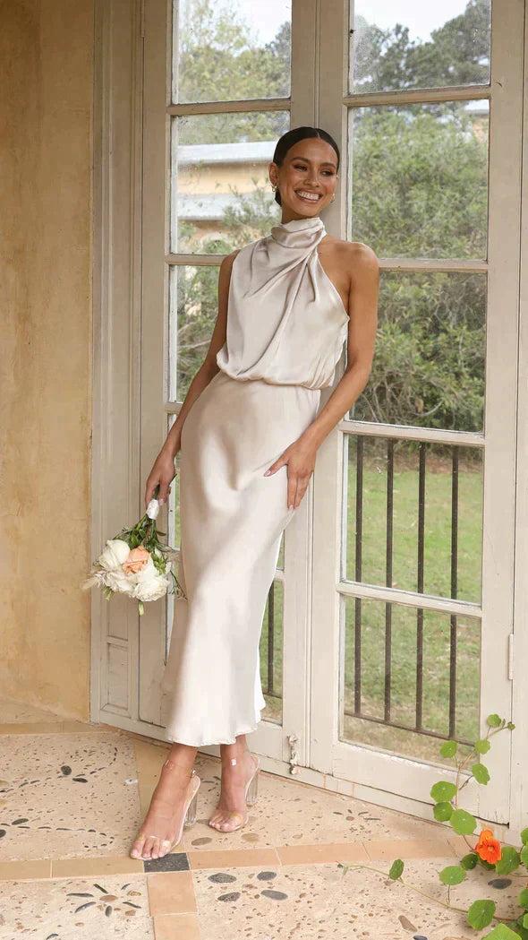 Elegant women's halter midi dress with a flattering flowing design, perfect for special occasions or cocktail parties.