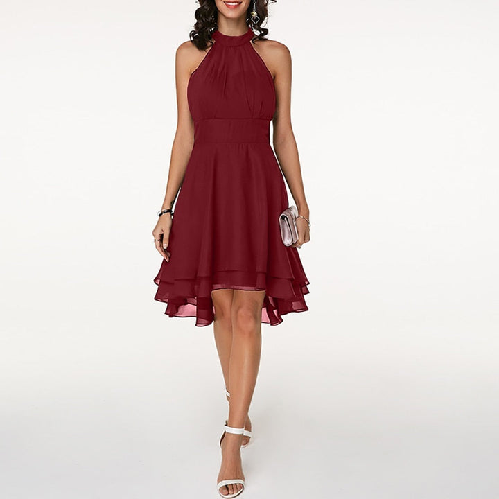 Women's elegant halter neck mini dress with flowing layered hem. Ideal for chic evening wear or parties.
