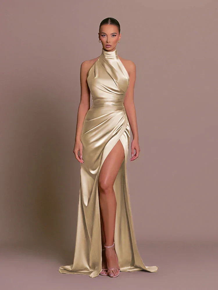 Gold Halter Neck Ruched Maxi Dress featuring an elegant high split. Ideal formal evening gown for women.