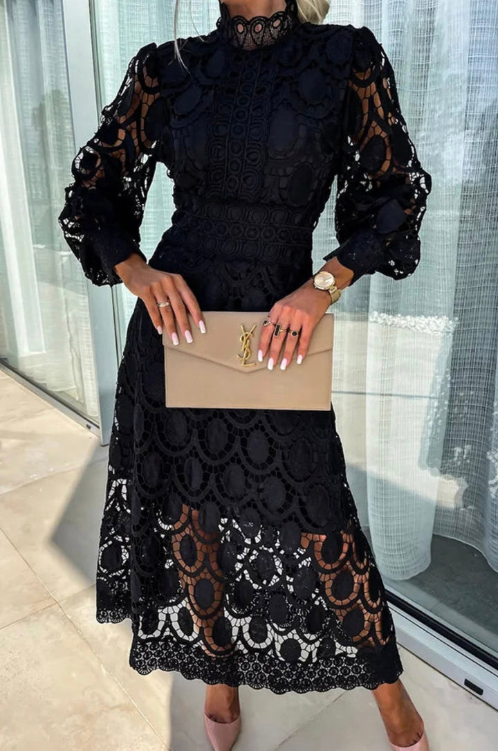 Formal women's midi dress featuring a high neck & long sleeves. A-line silhouette, perfect for cocktail parties.
