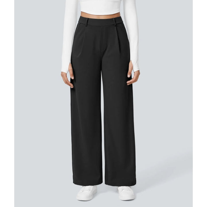Close-up of the fabric and pleating on women's high waisted wide leg tailored dress pants.
