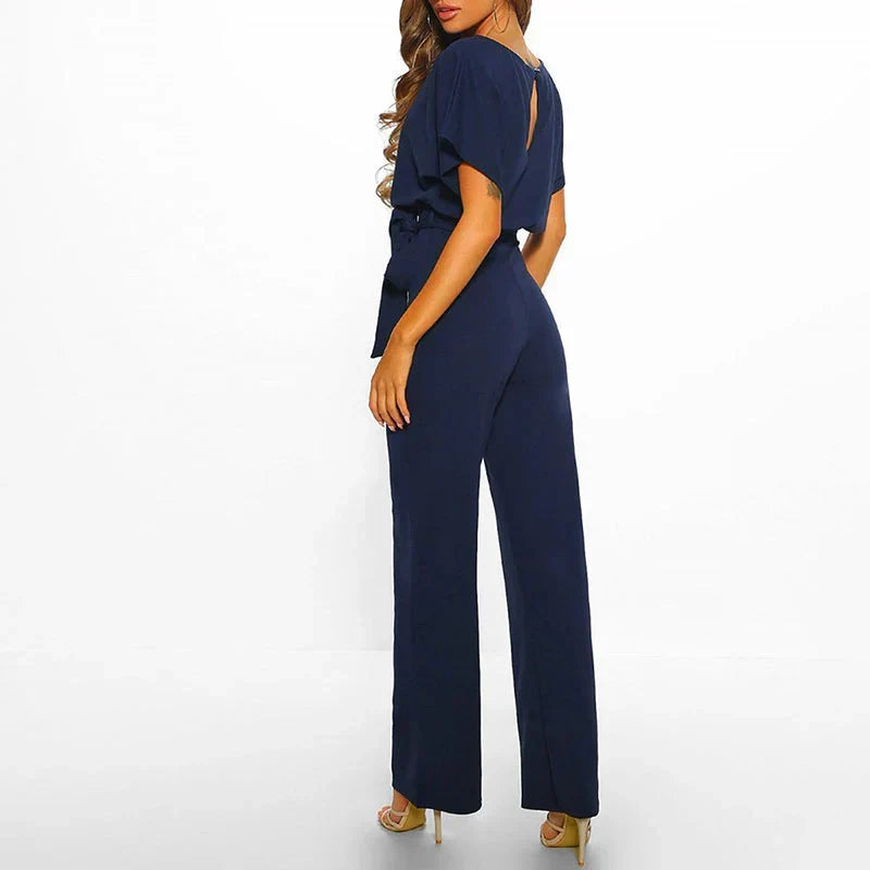 Modern women's elegant jumpsuit with a cinched slim waist and flowing design, offering a flattering drape.
