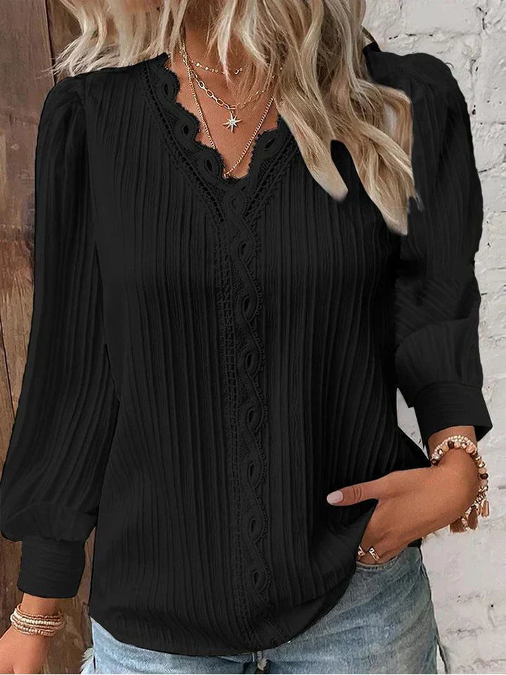Elegant women's lace blouse with delicate puff sleeves, perfect for chic spring fashion.