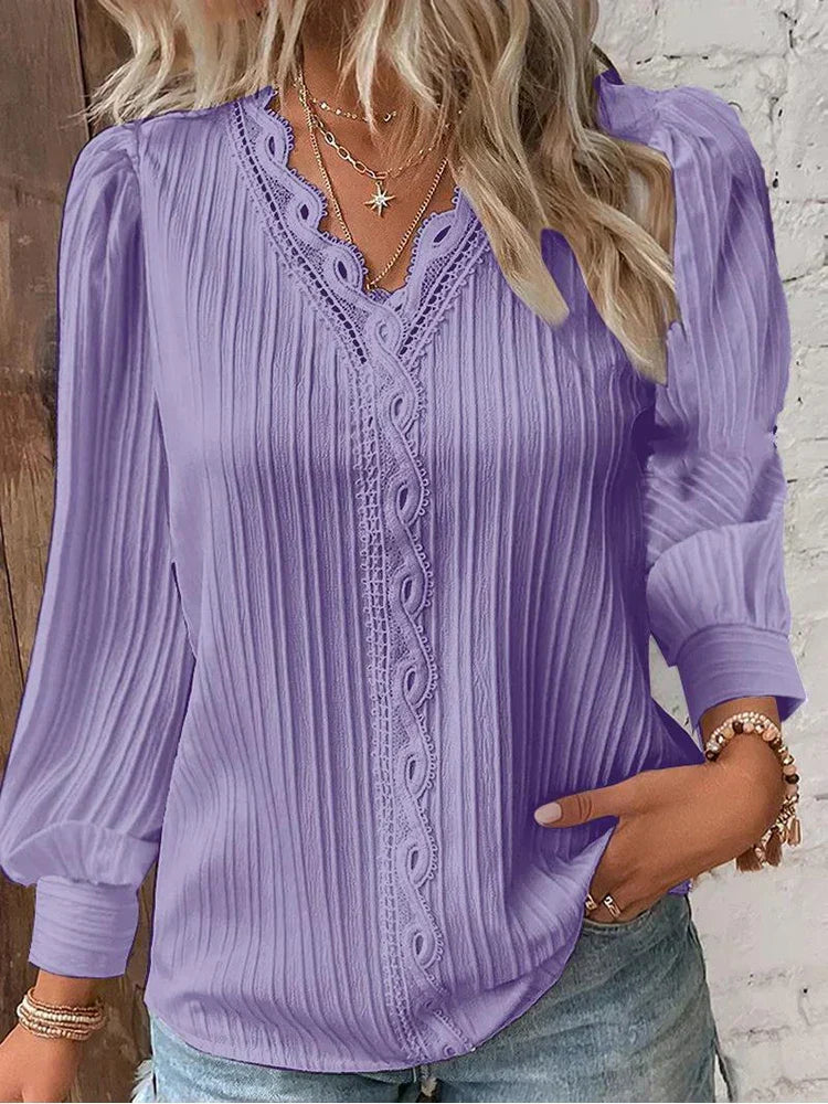 Delicate lace women's blouse with elegant puff sleeves, a chic top for any occasion.