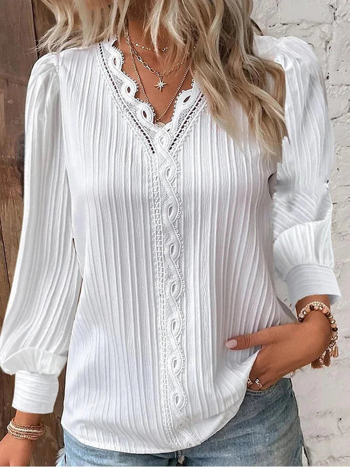 Feminine & elegant women's lace blouse, featuring fashionable puff sleeves for a sophisticated look.