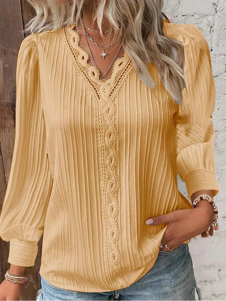 Relaxed fit women's lace top with puff sleeves, an elegant yet comfortable choice for everyday wear.