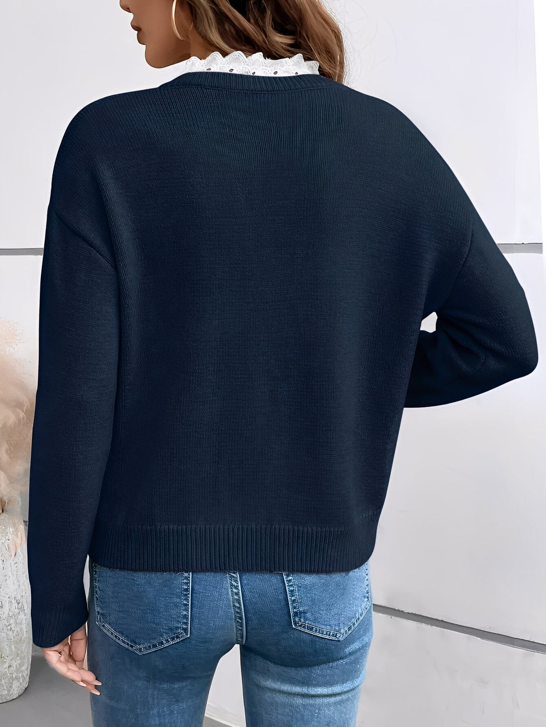 Comfortable women's V-neck pullover sweater with delicate lace trim, ideal for everyday wear.