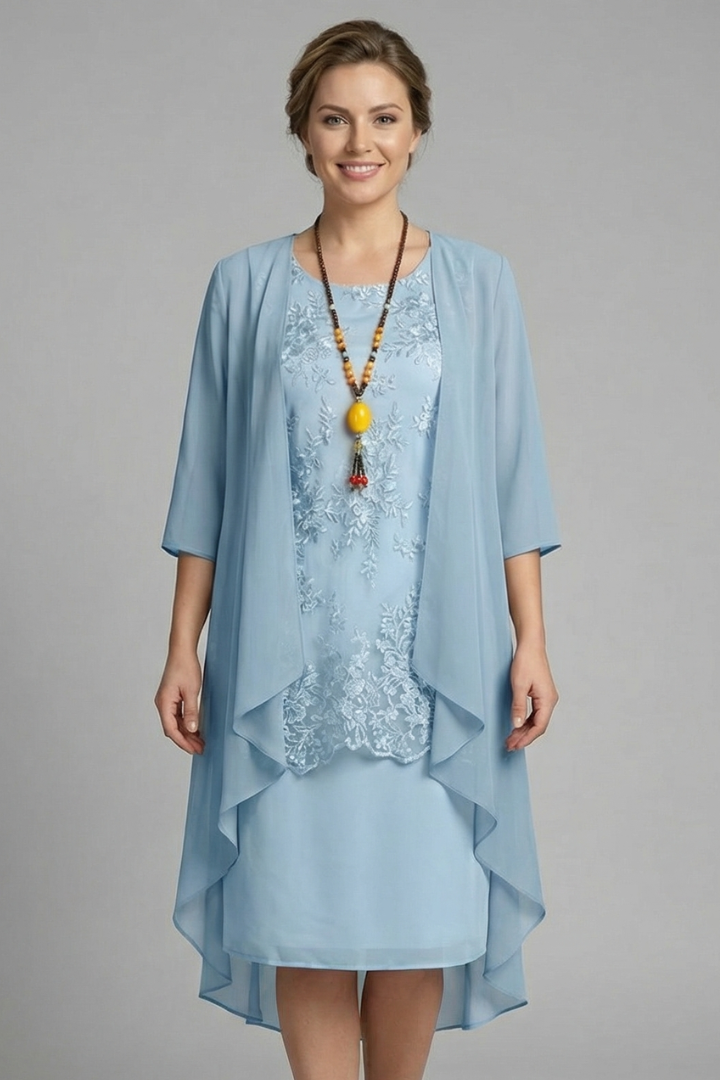 Women's round neck, short sleeve, knee-length dress featuring elegant layered sheer overlay and a stylish flared hem.