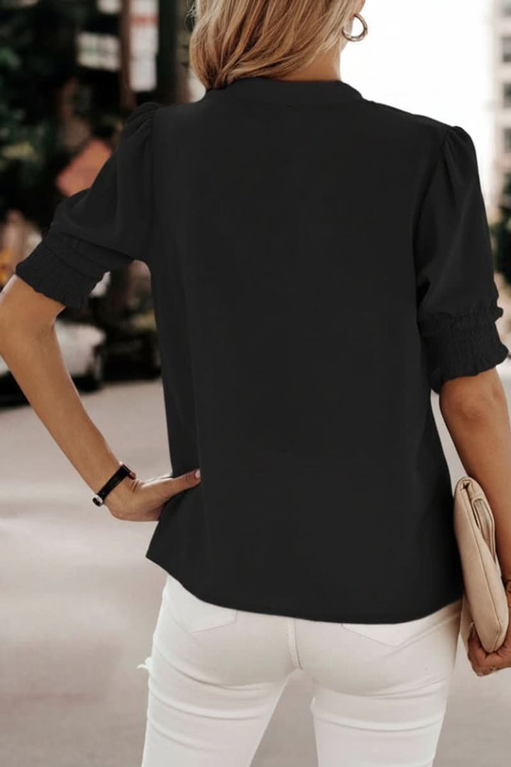 Chic V-neck blouse for women featuring trendy puff sleeves and a lightweight fabric, ideal for versatile styling.