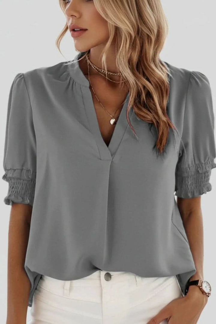 Women's elegant lightweight V-neck blouse with puff sleeves, a chic and comfortable top for any occasion.