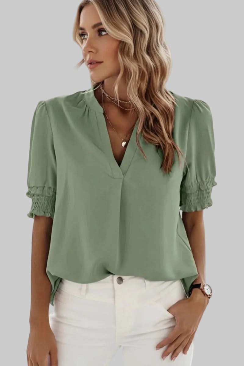 Trendy women's V-neck blouse featuring delicate puff sleeves and a lightweight design, perfect for sophisticated style.