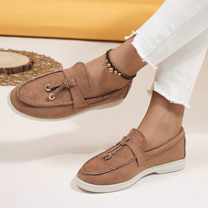 Elegant women's loafers with chic tassel detail. Perfect slip-on flats for sophisticated everyday style.