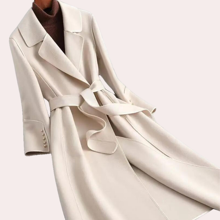 Women's elegant long coat. Double button front, belted waist for a flattering silhouette. Fall/winter fashion.